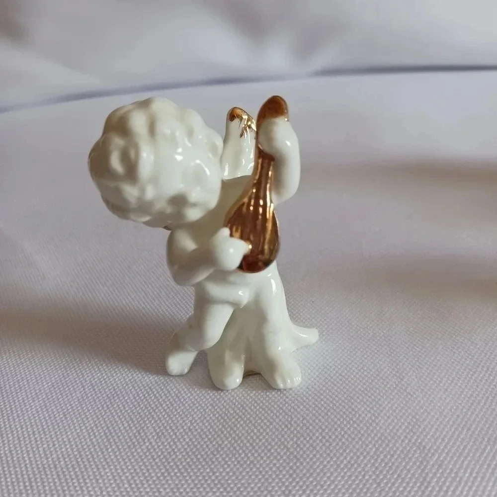 Bone china set of 4 angels gathered playing instruments